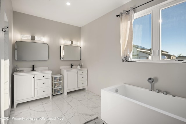 bathroom featuring vanity and a bath