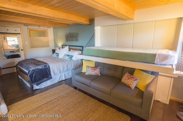 bedroom featuring beamed ceiling, dark wood-type flooring, and wooden ceiling