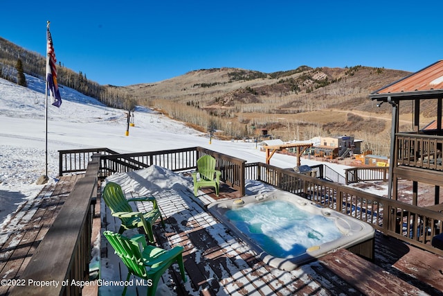 snow covered deck featuring a mountain view