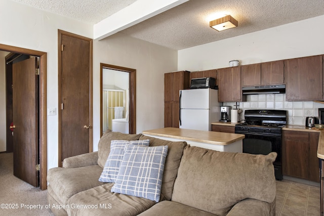 172 Sunny Acres Rd, Glenwood Springs, CO 81601 - kitchen with black appliances, under cabinet range hood, a textured ceiling, backsplash, and light countertops
