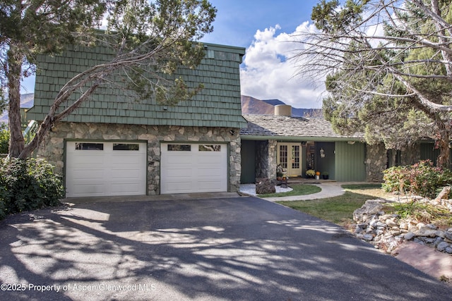 172 Sunny Acres Rd, Glenwood Springs, CO 81601 - view of front of property featuring stone siding, driveway, french doors, and a garage