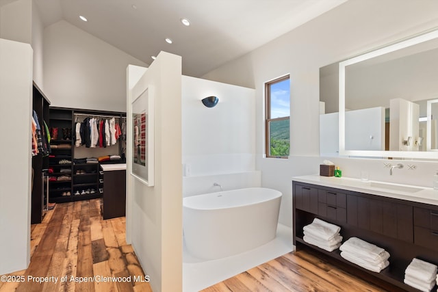 1000 Lazy O Rd, Snowmass, CO 81654 - full bath with a freestanding tub, vanity, wood finished floors, and a walk in closet