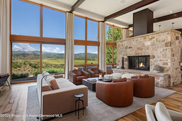 1000 Lazy O Rd, Snowmass, CO 81654 - living area with wood-type flooring, a high ceiling, a mountain view, and beam ceiling
