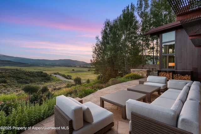 1000 Lazy O Rd, Snowmass, CO 81654 - patio terrace at dusk with an outdoor living space and a mountain view