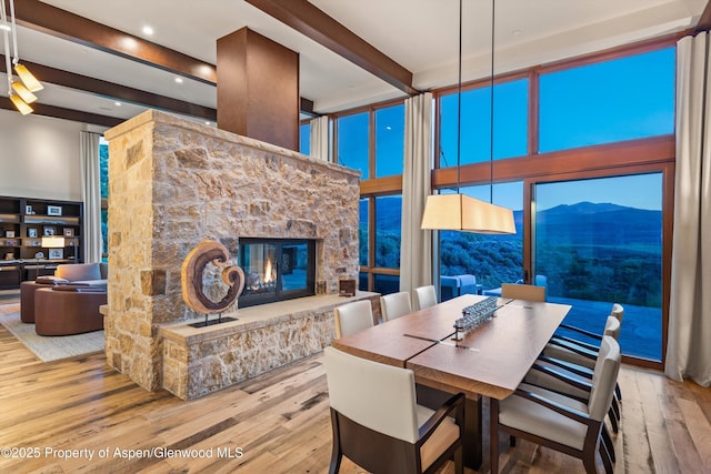 1000 Lazy O Rd, Snowmass, CO 81654 - dining space with a towering ceiling, a fireplace, wood finished floors, a mountain view, and recessed lighting