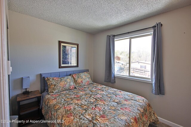 bedroom featuring a textured ceiling