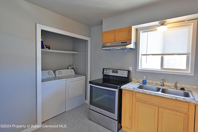 kitchen with washer and dryer, stainless steel electric stove, and sink