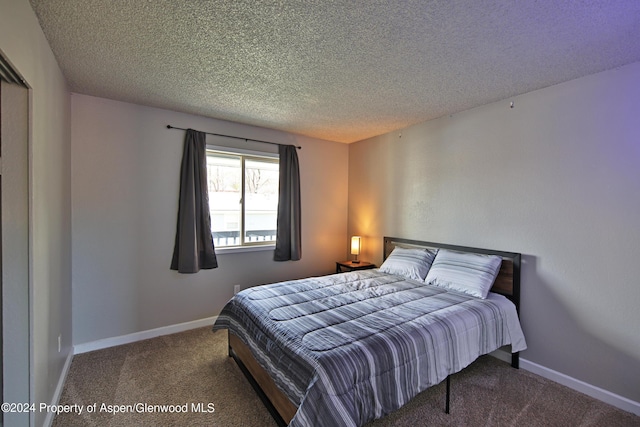 carpeted bedroom with a textured ceiling