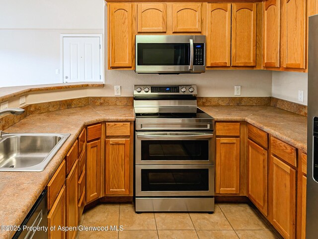 612 Riverview Dr Unit 808, New Castle, CO 81647 - kitchen featuring stainless steel appliances, a sink, light tile patterned flooring, and light countertops
