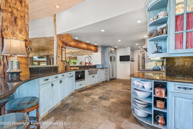 87 Magnifico Dr, Aspen, CO 81611 - kitchen with open shelves, dark stone finish floors, recessed lighting, arched walkways, and dark stone counters