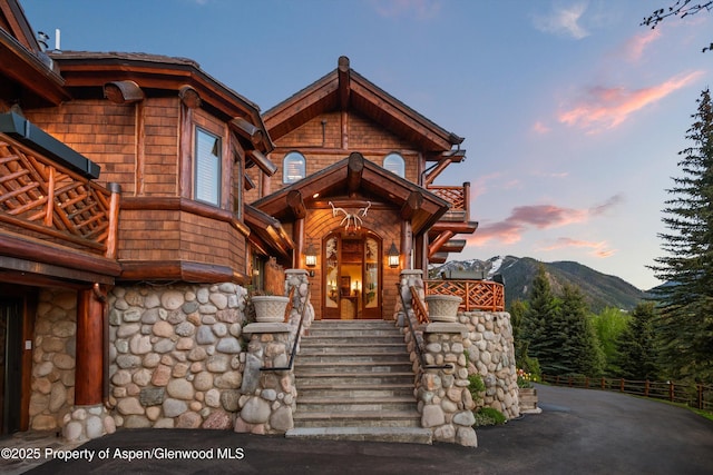 87 Magnifico Dr, Aspen, CO 81611 - entrance to property featuring a balcony, a mountain view, and stone siding