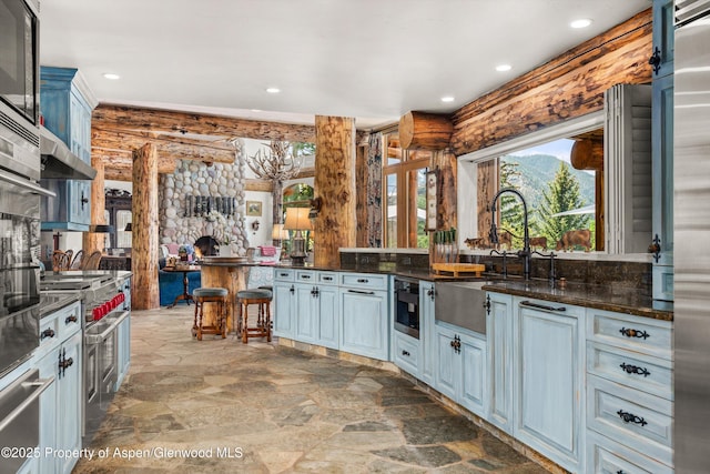 87 Magnifico Dr, Aspen, CO 81611 - kitchen featuring a warming drawer, stone finish floors, recessed lighting, double oven range, and under cabinet range hood