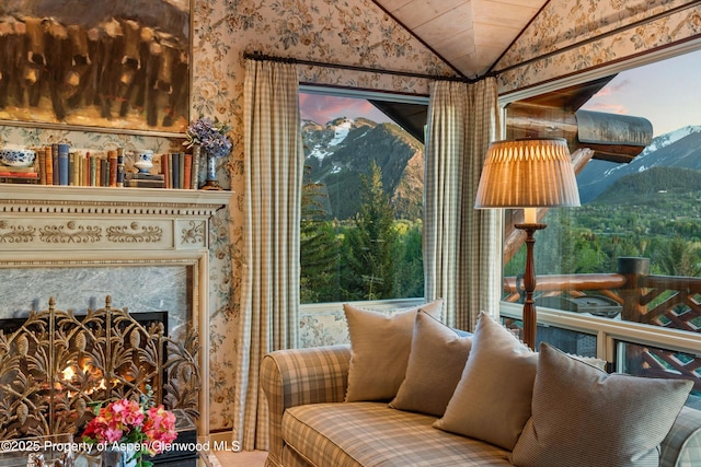 87 Magnifico Dr, Aspen, CO 81611 - sitting room featuring wallpapered walls, vaulted ceiling, and a mountain view