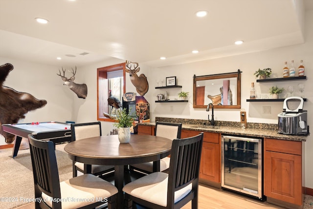 interior space featuring wine cooler, indoor wet bar, and light wood-type flooring