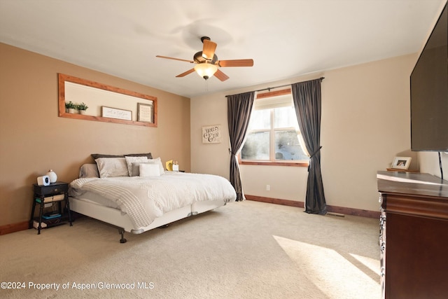 bedroom with light colored carpet and ceiling fan