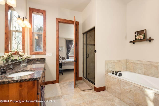 bathroom with tile patterned floors, vanity, and separate shower and tub