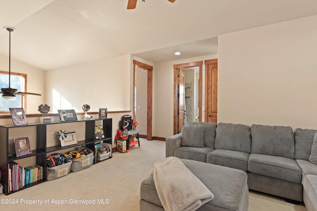 living room with lofted ceiling, light carpet, and ceiling fan