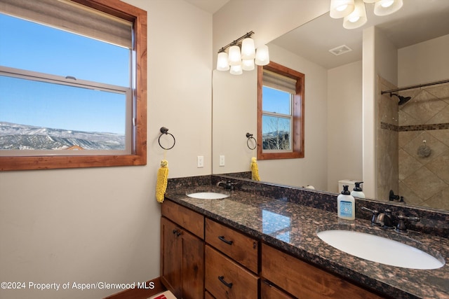 bathroom featuring vanity and a tile shower