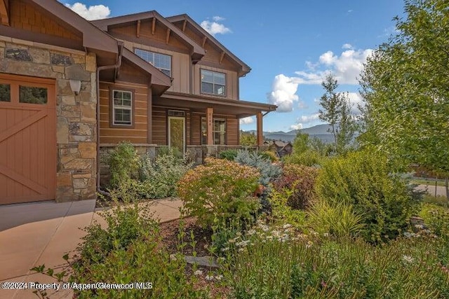 view of front of home with a mountain view, a garage, and a porch