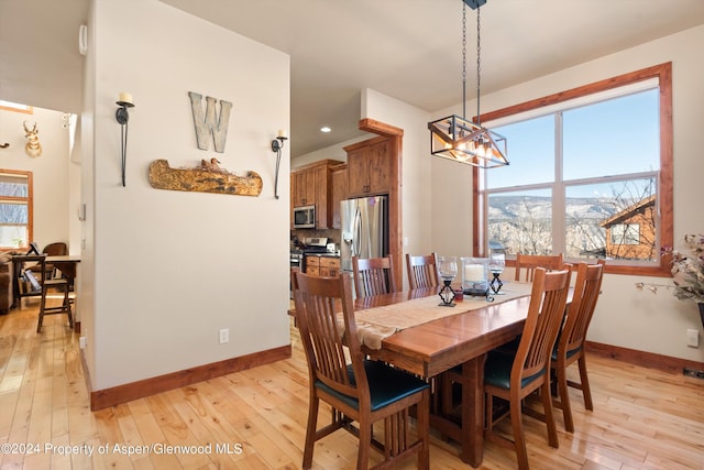 dining area featuring a chandelier and light hardwood / wood-style floors