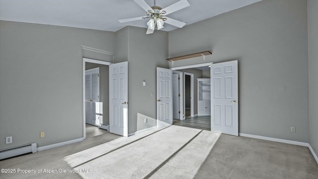 unfurnished bedroom featuring high vaulted ceiling, baseboard heating, carpet, and baseboards