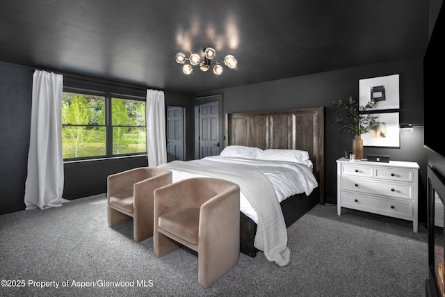 carpeted bedroom with a chandelier