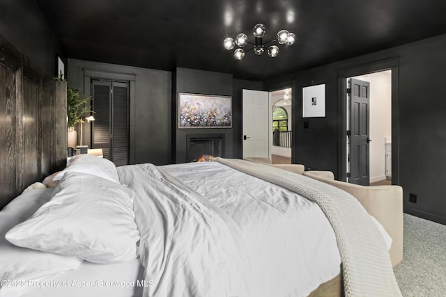 bedroom featuring a chandelier and carpet flooring