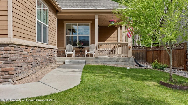 150 Castle Ct, New Castle, CO 81647 - view of exterior entry with covered porch, a shingled roof, and stone siding