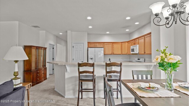 150 Castle Ct, New Castle, CO 81647 - dining room with light colored carpet, recessed lighting, and a chandelier