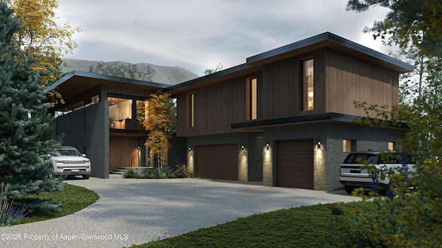 contemporary house featuring a garage and a mountain view