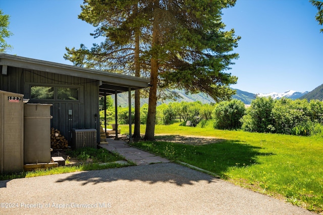 view of yard with cooling unit and a mountain view