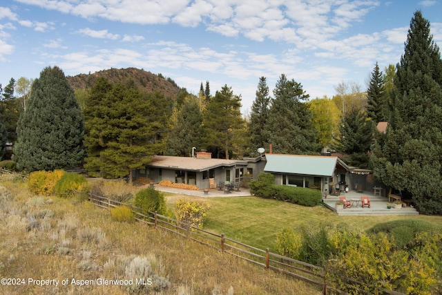 rear view of house with a yard and a patio