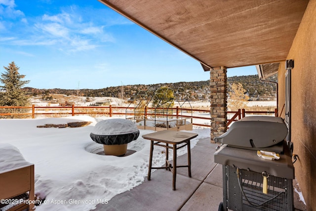 snow covered patio with area for grilling