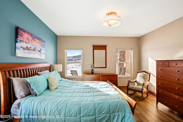 bedroom with baseboards and wood finished floors