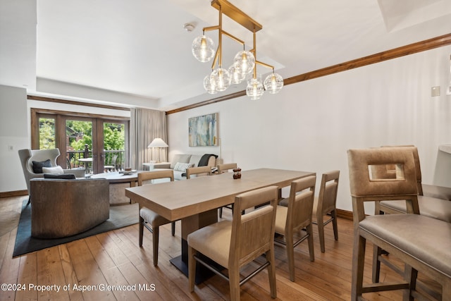 dining area with hardwood / wood-style floors and french doors