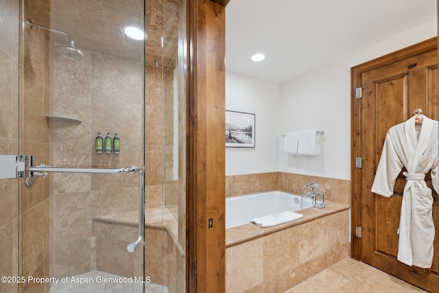 bathroom featuring tile patterned floors and separate shower and tub