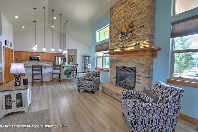 369 N Meadow Dr, Rifle, CO 81650 - living area with high vaulted ceiling, light wood finished floors, and a fireplace