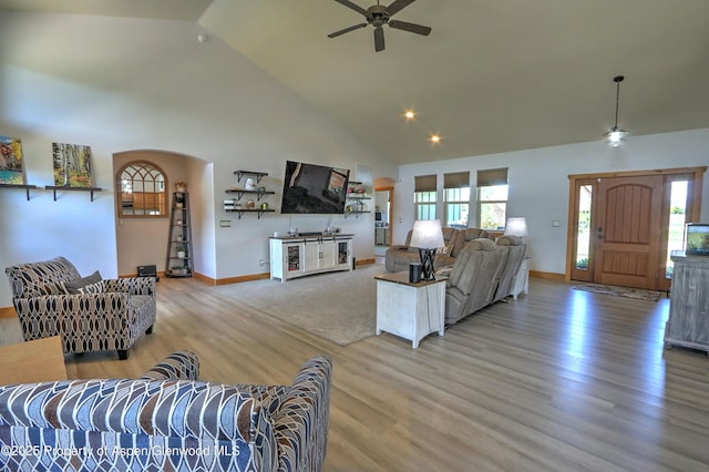 369 N Meadow Dr, Rifle, CO 81650 - living area featuring ceiling fan, light wood-style floors, high vaulted ceiling, and arched walkways