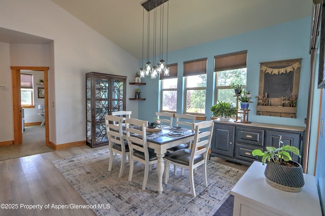 369 N Meadow Dr, Rifle, CO 81650 - dining room with light wood-style flooring, lofted ceiling, and a chandelier