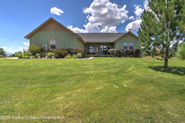 369 N Meadow Dr, Rifle, CO 81650 - view of front of house with board and batten siding and a front lawn
