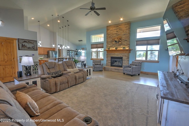 369 N Meadow Dr, Rifle, CO 81650 - living area featuring high vaulted ceiling, a ceiling fan, light wood finished floors, and a fireplace