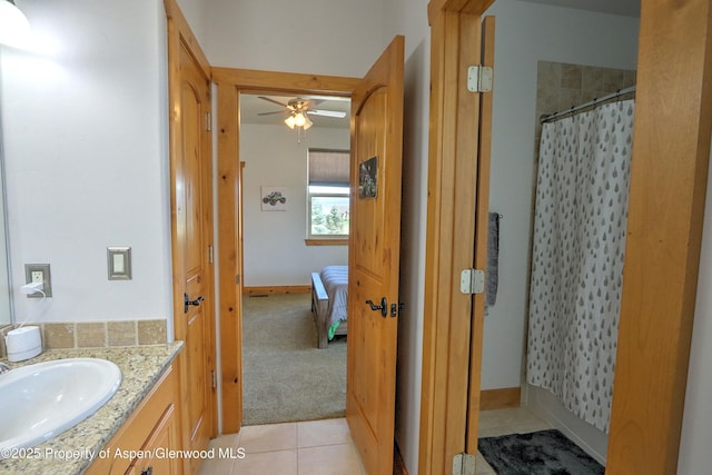 369 N Meadow Dr, Rifle, CO 81650 - ensuite bathroom with vanity, a ceiling fan, a shower with shower curtain, and tile patterned flooring