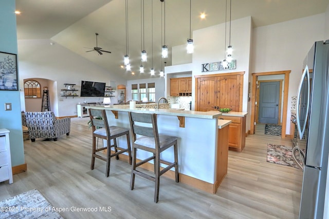 369 N Meadow Dr, Rifle, CO 81650 - kitchen featuring freestanding refrigerator, high vaulted ceiling, a ceiling fan, light countertops, and light wood-style floors