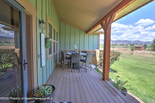 369 N Meadow Dr, Rifle, CO 81650 - deck featuring a mountain view, a lawn, and outdoor dining space