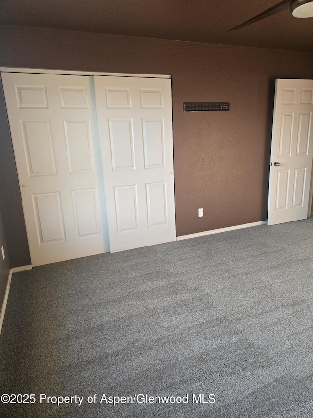 180 E 26th St, Rifle, CO 81650 - unfurnished bedroom featuring carpet, a closet, and baseboards