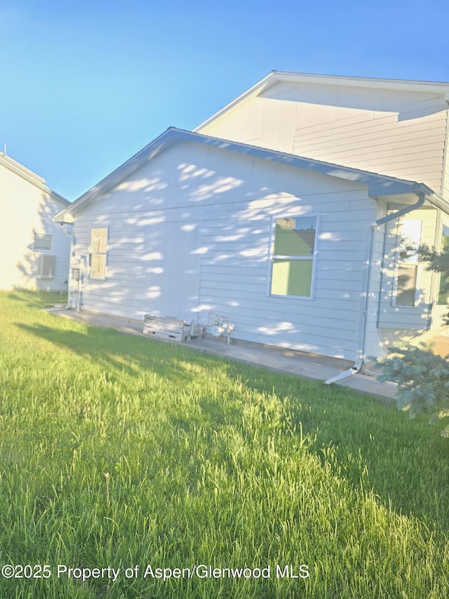 180 E 26th St, Rifle, CO 81650 - view of side of home with a lawn