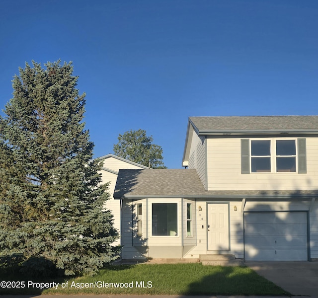 180 E 26th St, Rifle, CO 81650 - view of front of property featuring an attached garage, a shingled roof, and concrete driveway