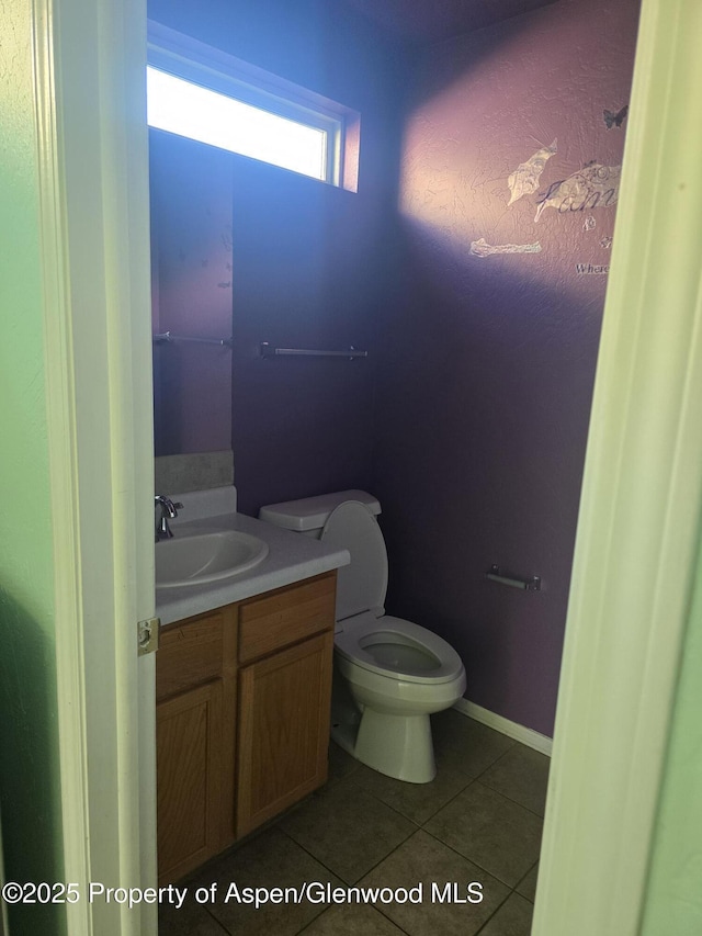 180 E 26th St, Rifle, CO 81650 - bathroom featuring vanity, tile patterned floors, and toilet