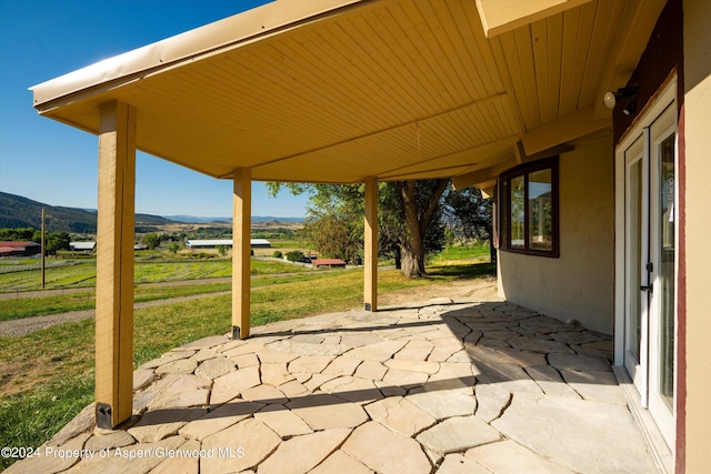 view of patio with a mountain view and a rural view