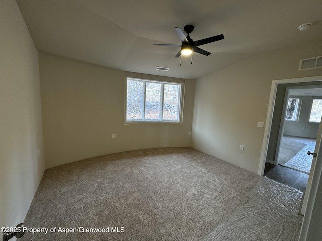 spare room with carpet floors and ceiling fan